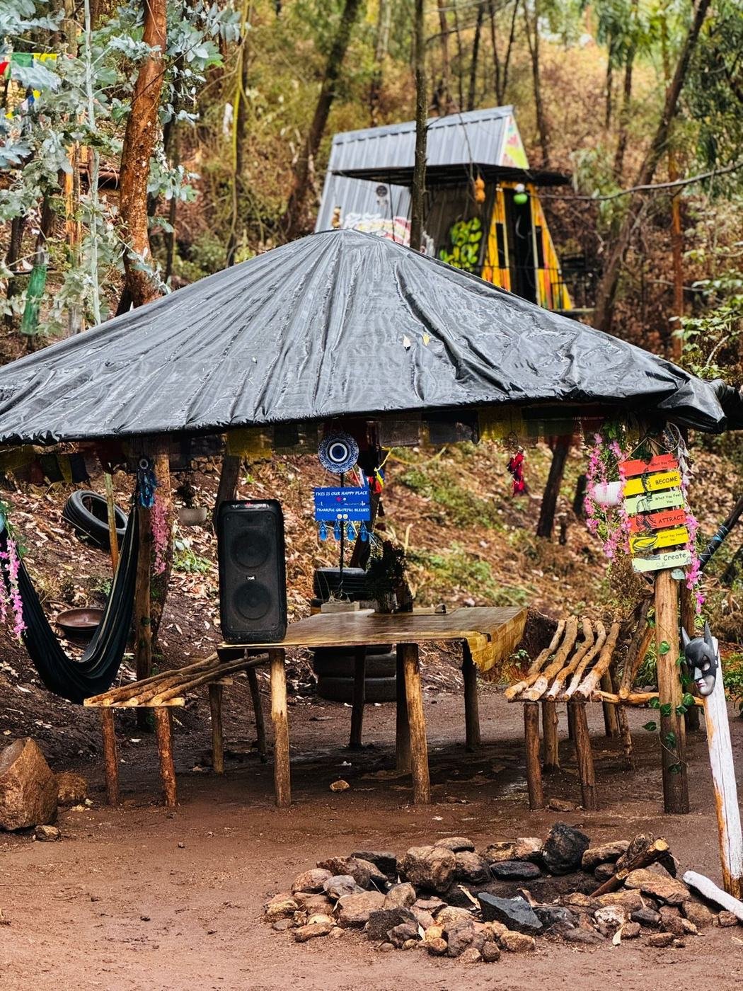 Common hut with hammocks and bonfire pit at Mowgli Camp